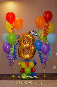 balloons and streamers surround the number eight balloon arrangement