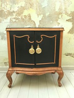 an old fashioned black and gold cabinet