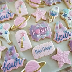 decorated cookies are displayed on a tray