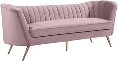 a pink velvet couch with gold legs