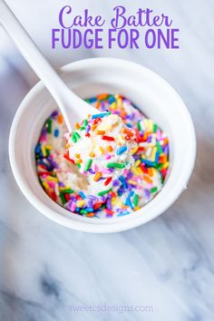 a bowl filled with sprinkles and ice cream on top of a table