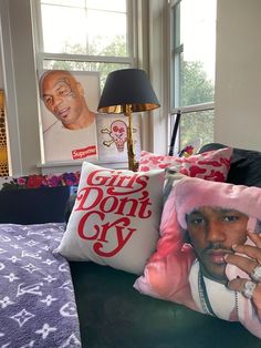 a bed with two pillows on top of it next to a lamp and a window