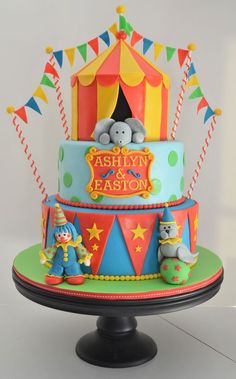 there is a multi layer cake decorated with circus animals