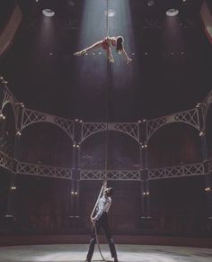 two people are performing aerial acrobatic tricks