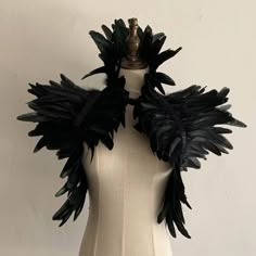 a mannequin with black feathers on it