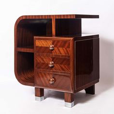 a wooden cabinet with two drawers on one side and an open drawer on the other