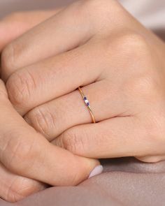 a woman's hand with a ring on it