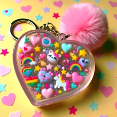 Check out this adorable, heart-shaped resin art keychain! It features a clear resin base filled with cute mini stickers of unicorns, hearts, stars, and rainbows. It's extra glossy and topped off with a fluffy, pink pompom! Perfect for any teenage girl. #ResinArt #CuteKeychain #TeenAccessories #UnicornLove #SparklingDesign #GiftForGirl Kawaii Resin Art, Resin Unicorn Ideas, Pink Resin Keychain, Resin Heart Keychain, Best Kids Watches, Alter Decor, Colorful Keychain, Lol Doll Cake, Kawaii Resin Charms