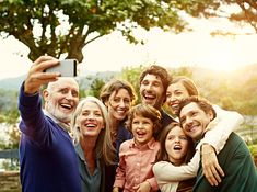 a family taking a selfie with their cell phone