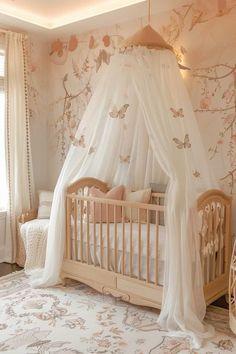 a baby's room with a canopy bed and crib in the middle of it