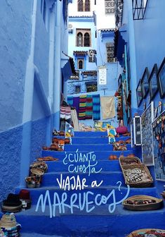 an alleyway with blue painted steps and pictures on the wall