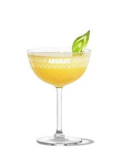 an alcoholic cocktail with lime garnish in a coupe glass on a white background