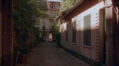 an alley way with many windows and shutters