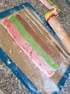 a piece of cake sitting on top of a counter next to a rolling pin