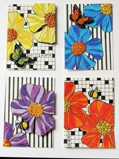 four different colored flowers are on the checkered paper