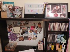 a book shelf filled with lots of different types of books and cds on top of it