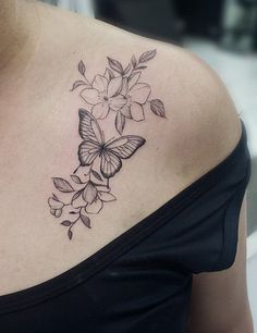 a woman with a butterfly tattoo on her shoulder