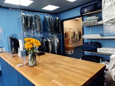 a room with blue walls and shelves filled with clothes