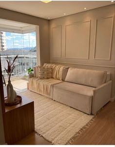 a living room filled with furniture and a large window