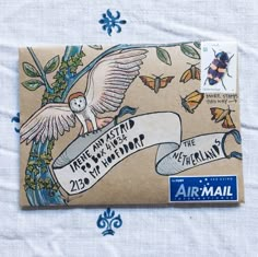 an airmail envelope with a drawing of a bird on it's back and banner