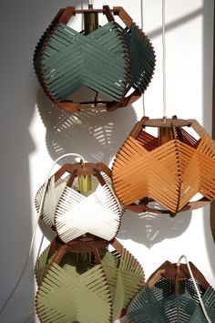 four different colored lamps hanging from the ceiling