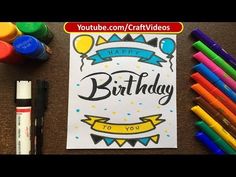 the birthday card is next to markers, crayons and markers on the table