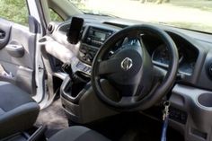 the interior of a vehicle with steering wheel and dashboard