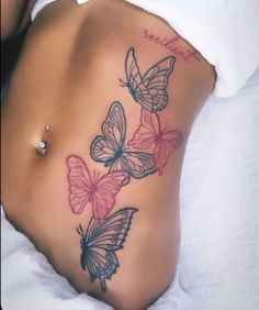 a woman's stomach with three butterflies on it