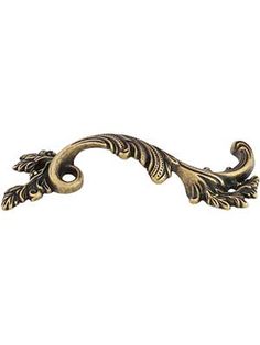 an ornate brass handle on a white background