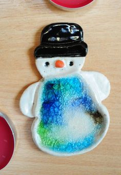 a snowman cookie sitting on top of a wooden table