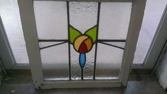 a stained glass door with a flower on it