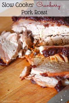 slow cooker cranberry pork roast on a cutting board next to a knife