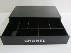 a black box that has some drawers in it and the word chanel written on it