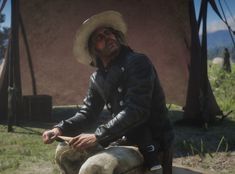 a man in a cowboy hat is petting a dog on the back of a motorcycle