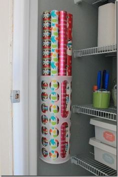 rolls of toilet paper are on the shelf in the closet next to the refrigerator door