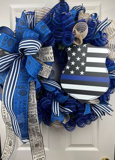 a blue and white wreath with an american flag on it, hanging from the front door