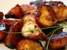 grilled potatoes on a white plate with green garnish