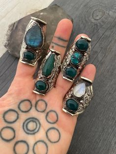 A unique unisex Boho style chunky ring, made out of white metal and Jade stones, Labradorite, Turquoise and moonstone. The band has embossed details and the ring is size adjustable for you to choose in which finger you want to wear it. Being size adjustable makes this ring the perfect gift for your love one. A must have addition to your jewelry collection. Choose your favorite from 6 different styles. Style 1- 2 inch- 5cm long Style 2- 1.90 inch- 4.7cm long Style 3- 1.60 inch- 4cm long Style 4- Chuncky Ring, Chunky Stone Rings, Jade Gemstone Ring Jewelry, Unique Jade Gemstone Jewelry, Jade Rings, Chunky Ring, Unique Jade Gemstone Ring, Vintage Jade Ring Jewelry, Handmade Green Jade Rings