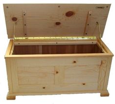 a wooden chest with measuring tape on the top and bottom section in front of it