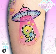 an alien tattoo on the leg of a woman's legs with hearts and stars