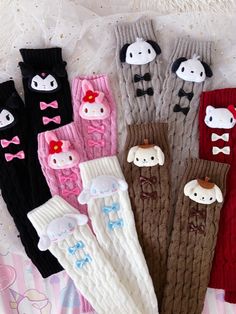 five pairs of knitted baby leg warmers with bow ties and bows on them