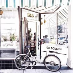 an old bike parked in front of a restaurant