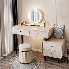 a dressing table and stool with a round mirror on it in front of a window