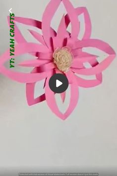 an origami flower made out of pink paper on a white background with the words,