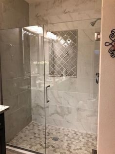 a walk in shower sitting inside of a bathroom