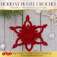 a red crochet snowflake on top of a white wooden table next to christmas decorations