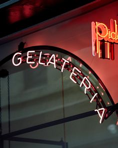 a neon sign that reads gelaterria on the side of a building