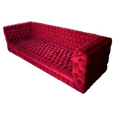 a large red couch sitting on top of a white floor