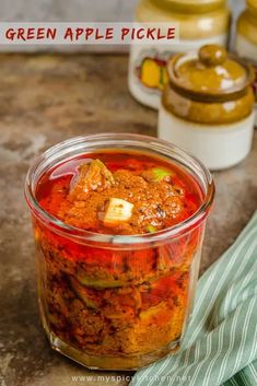 a jar filled with pickles sitting on top of a counter