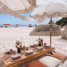 a picnic table set up on the beach for two